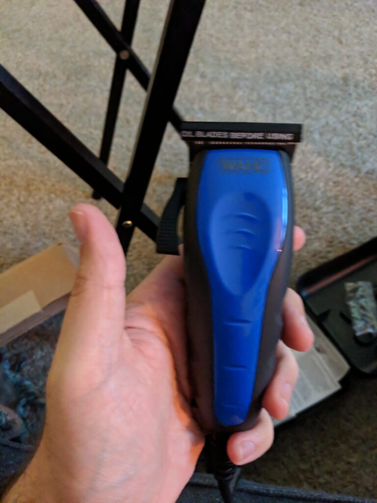 An electric hair clipper held by someone who clearly should not be trusted with one.